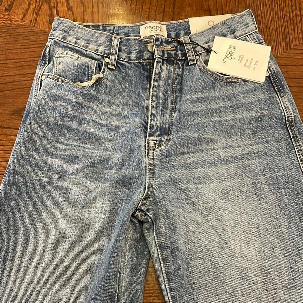 5/26 medium denim jeans with slits at the ankle.